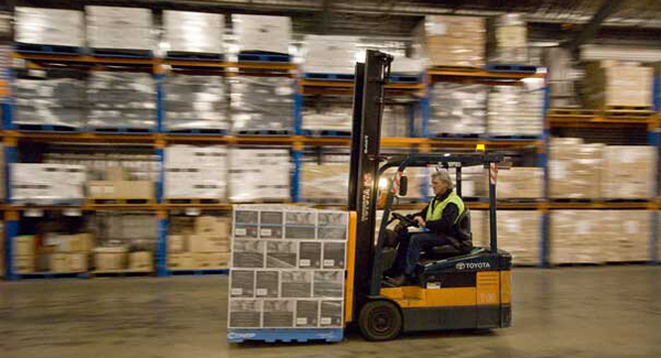 forklift moving a pallet in warehouse